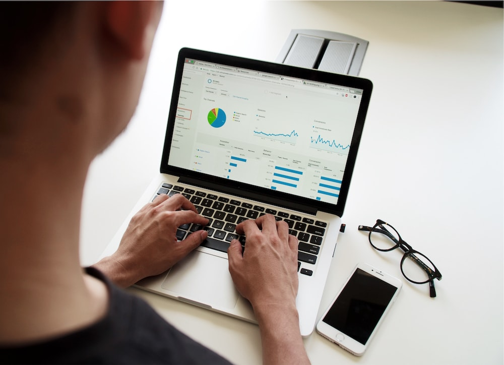 An HR manager using an HR dashboard on his laptop