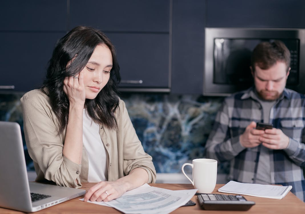 Man and woman stressed while doing personal finances management