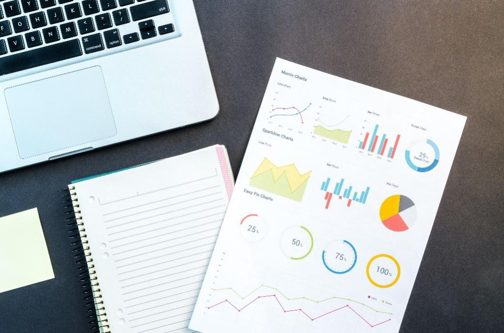 A document with graphs placed on a work desk